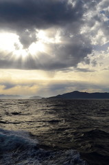 Obraz premium the setting sun in the clouds over the Aegean Sea