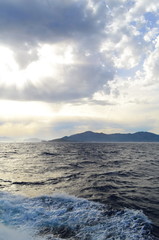 Fototapeta premium the setting sun in the clouds over the Aegean Sea