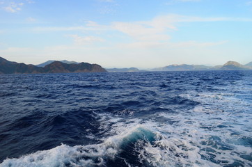 the setting sun in the clouds over the Aegean Sea