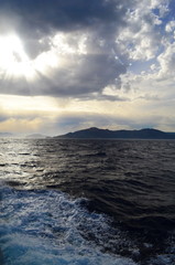 Obraz premium the setting sun in the clouds over the Aegean Sea