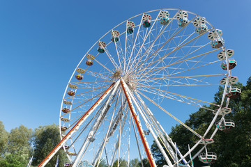 Fototapeta premium Big ferris wheel in front of blue sky in summer