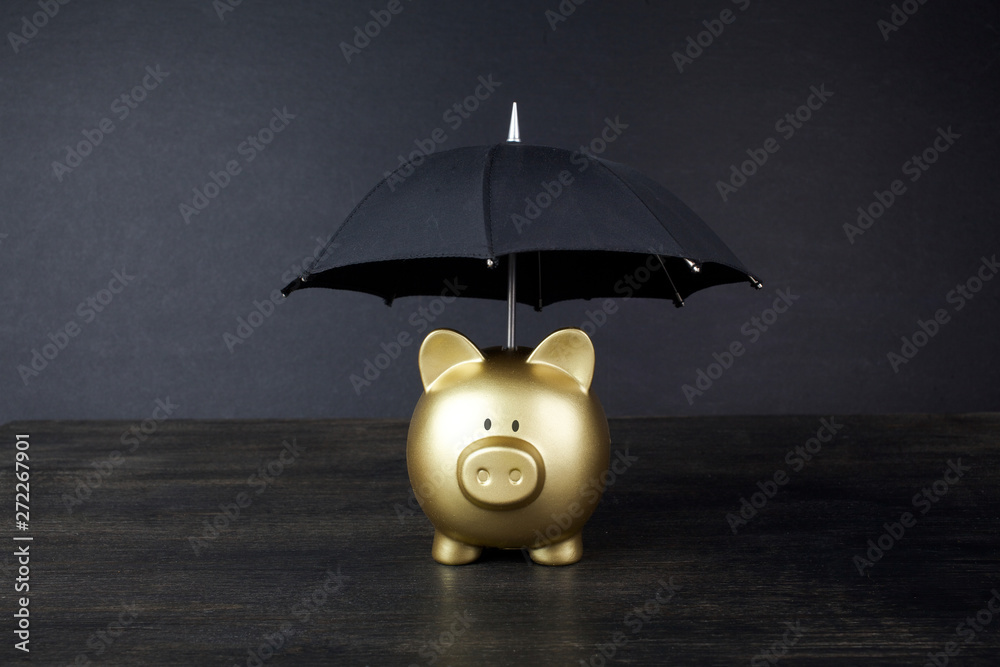 Wall mural Gold Piggy bank with umbrella concept for finance insurance, protection, safe investment or banking