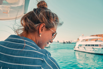 Fototapeta premium Cruise ship vacation woman enjoying travel vacation at sea. Free carefree happy girl looking at ocean or sea. Woman on a yacht enjoying the beautiful vacation.