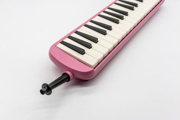 Musical pink melodian isolated on white