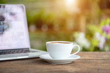 White ceramic coffee cup on wooden table or counter