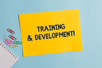 Text sign showing Training And Development. Business photo showcasing Organize Additional Learning expedite Skills Plain cardboard and writing equipment placed above pastel colour backdrop