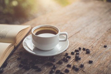 White ceramic coffee cup of black hot americano on wooden table