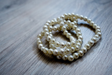 pearl necklace on gray background