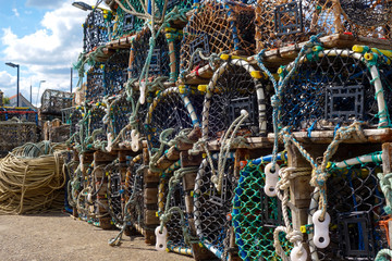 Lobster pots lined up on the jetty in the south bay at scarborough yorkshire england