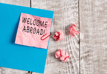 Writing note showing Welcome Abroad. Business concept for something that you say when someone gets...