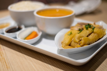 Hainanese chicken rice with sauce soup and salad.