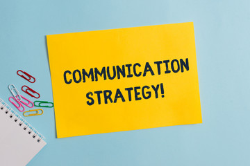 Text sign showing Communication Strategy. Business photo showcasing Verbal Nonverbal or Visual Plans of Goal and Method Plain cardboard and writing equipment placed above pastel colour backdrop