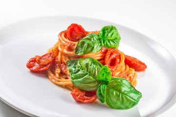 Plate of spaghetti with tomato and basil