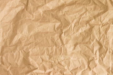 Obraz premium Crumpled gold paper background texture. Brown crumpled paper background