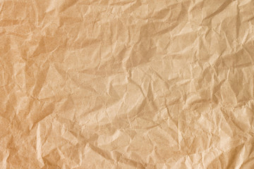Crumpled gold paper background texture. Brown crumpled paper background