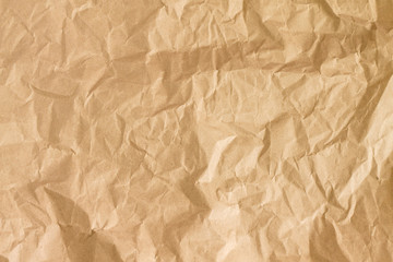 Crumpled gold paper background texture. Brown crumpled paper background