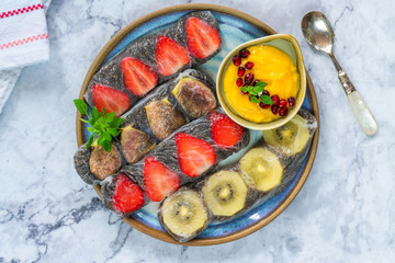 Chia seeds and fruit rice paper rolls with mango dipping sauce - top view