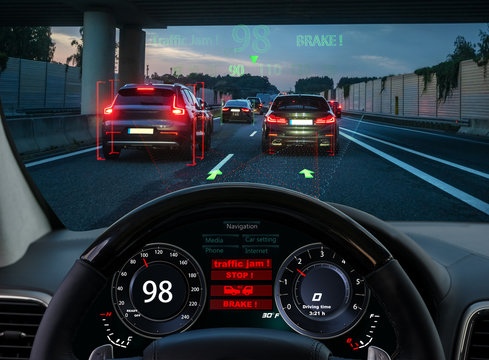 view from the cockpit of a car equipped with HUD and active safety systems.The systems detected a traffic jam on the motorway and activated emergency braking