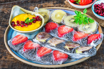 Chia seeds and fruit rice paper rolls with mango dipping sauce