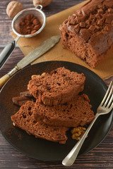 Piece of chocolate cake , fudge or pound cake. Wooden background.
