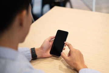 young man using mobile phone. mobile showing blank screen.