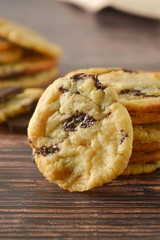 Homemade chocolate cookies on wooden table.