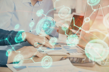 Social network theme hologram with businessman working on computer on background. Multi exposure.