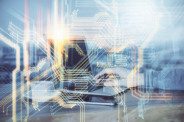 Double exposure of world map hologram with man working on computer on background. Concept of worldwideweb.