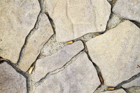 Paving of a path under a light natural stone