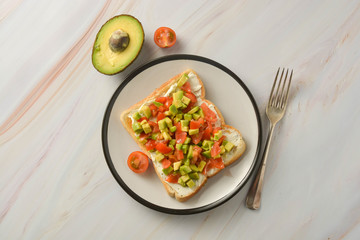 Toast with cream cheese, avocado and cherry tomatoes. Healthy food.