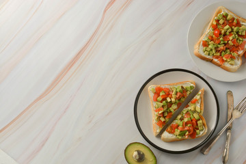 Toast with cream cheese, avocado and cherry tomatoes. Healthy food. Copy space.