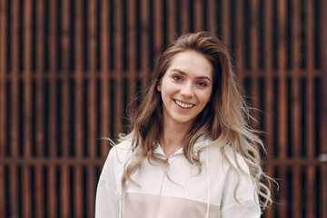 Portrait young woman in a pink sports suit.