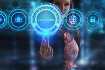 The concept of business, technology, the Internet and the network. A young entrepreneur working on a virtual screen of the future and sees the inscription: Outsourcing