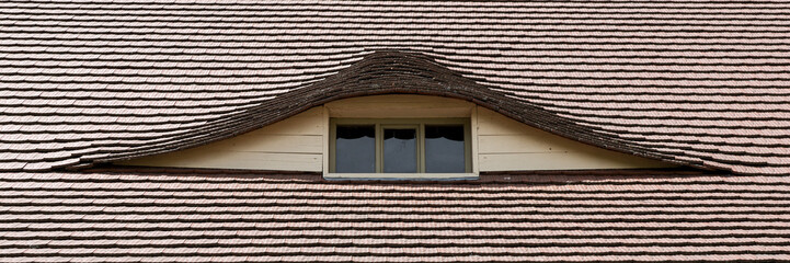 Semi-circular window in the roof in a country cottage