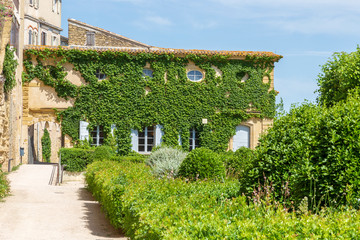 Fototapeta na wymiar Lauris, France. 06-05-2019. Old houses and garden at Lauris village in Provence, France.