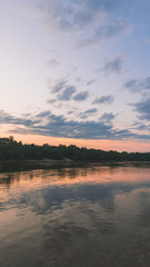 Fototapeta na wymiar beautiful sunset over the river, flying seagulls