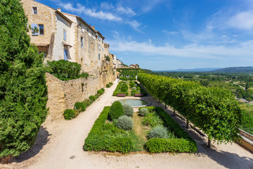 Fototapeta premium Lauris, France. 06-05-2019. Old houses and garden at Lauris village in Provence, France.