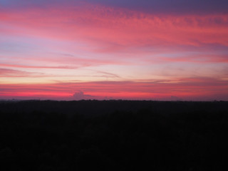 Silhouette sunset sky background. Twilight natural sunset sunrise over forest mountain. Warm color sky orange blue purple.