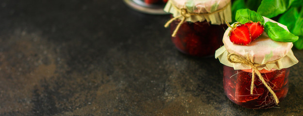 strawberry jam, ripe and juicy berries in a sweet dessert with basil. food background. top view. copy space