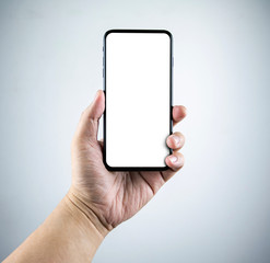 Man hand holding the smartphone full screen with blank screen . isolated on gray background.