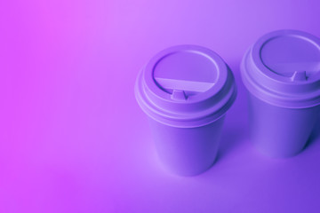 Paper disposable cups in trendy neon light.