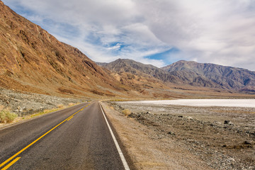 Desert road leading through Death Valley National Park, California USA.