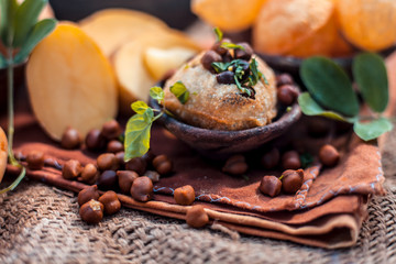 Famous Indian & Asian street food dish i.e. Panipuri snack in a clay bowl along with its flavored spicy water in another clay vessel. Entire consisting raw ingredients present on the surface.