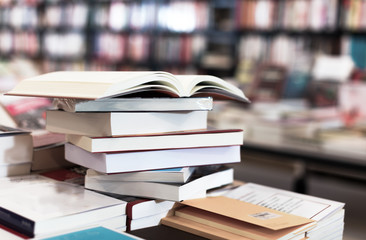 different books lying on table in library