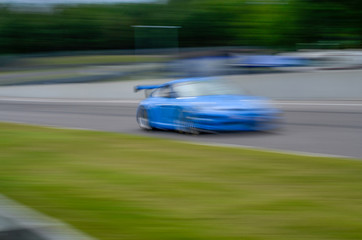 Obraz na płótnie Canvas Race car at speed on track
