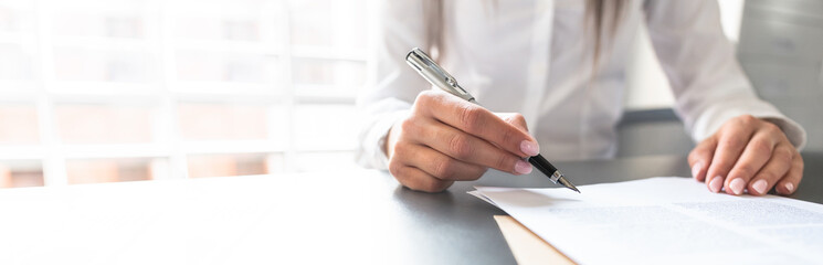 Business woman signing contract, making a deal.