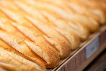Fresh baked bread in supermarket. Detail of a fresh baked bread in a row  in supermarket