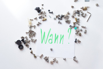 silver and black screws on the white surface