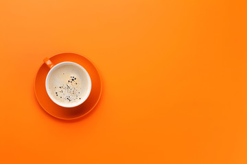 Orange coffee cup over orange background