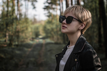 girl in sunglasses in the forest